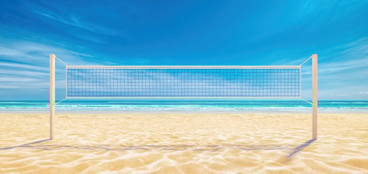 The volleyball net standing by the beautiful beach under a clear blue sky. photo