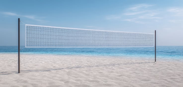 The volleyball net beautifully positioned on a tranquil beach by the sea photo