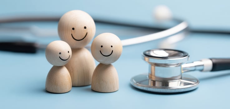 The wooden family figures representing health and happiness in a healthcare context. photo