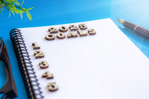 2025 New Year goal, plan, and action concepts. 2025 goals Text on Note Pad with calendar, glasses on the table.New Year's resolutions plan.Happy New Year theme, top view5 photo