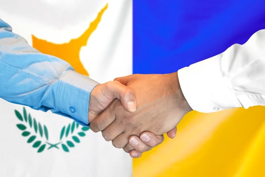 Handshake on Cyprus and Ukraine flag background. photo