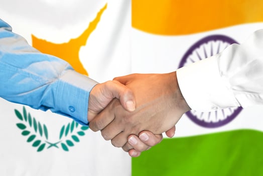 Handshake on Cyprus and India flag background. photo