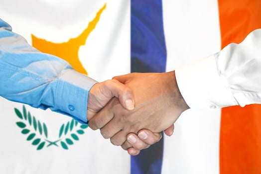 Handshake on Cyprus and France flag background. photo