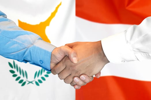 Handshake on Cyprus and Austria flag background. photo