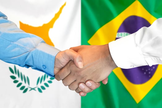 Handshake on Cyprus and Brazil flag background. photo