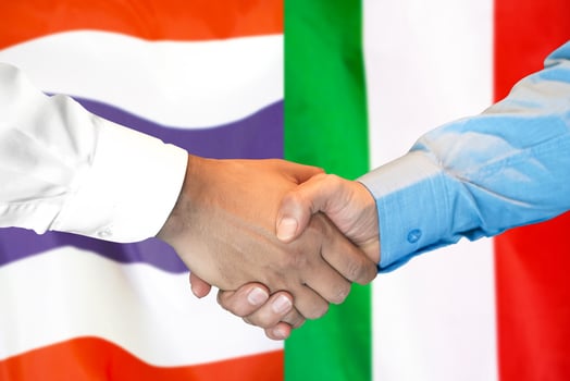 Handshake on Thailand and Italy flag background. photo