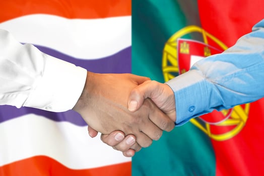Handshake on Thailand and Portugal flag background. photo