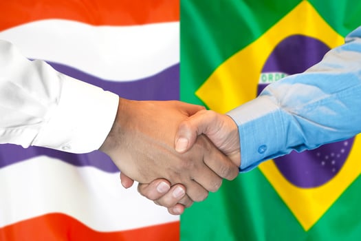 Handshake on Thailand and Brazil flag background. photo