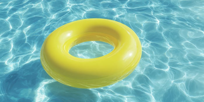 The vibrant yellow floaty relaxing in crystal clear pool water photo