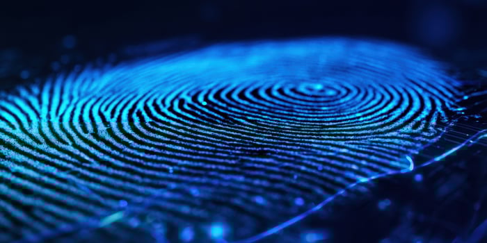 The intricate fingerprint pattern glowing in blue light with a modern touch. photo