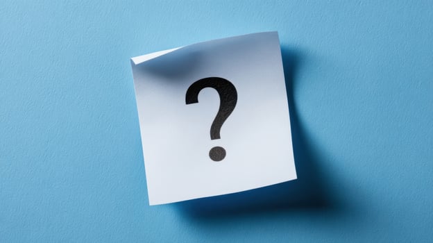 The Sticky Note Featuring a Question Mark on a Blue Background photo