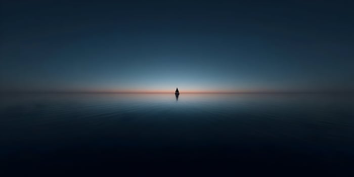 Sailboat on calm water at sunset photo