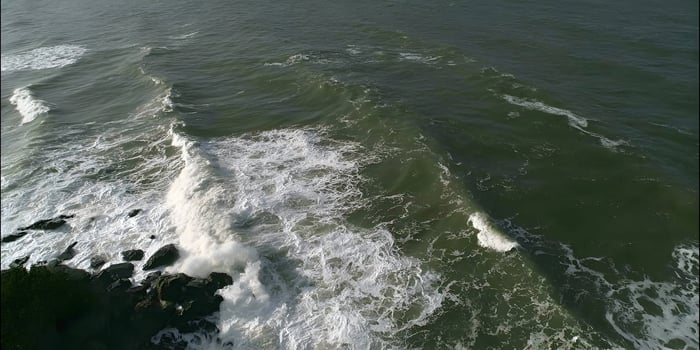 Ocean waves crashing against rocks on a coast photo