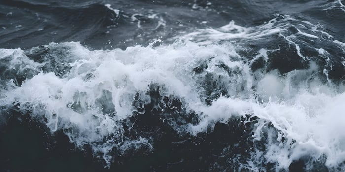 Close up view of ocean waves with white foam crashing photo