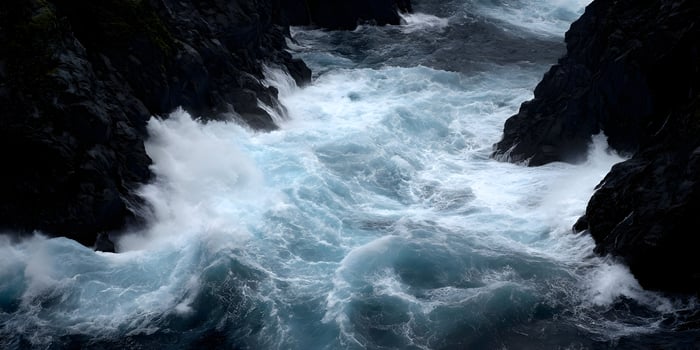 aerial ocean waves dark rocks photo