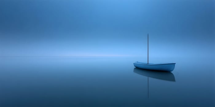 Small blue boat floats on calm water under a blue sky photo