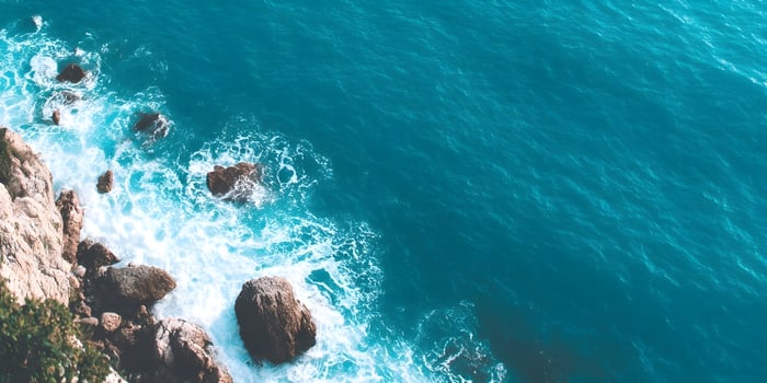 top view of ocean and rocky shore photo