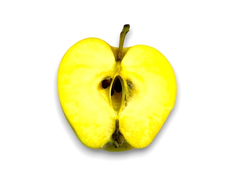 A sliced yellow apple sits prominently against a plain white background in this high resolution photo