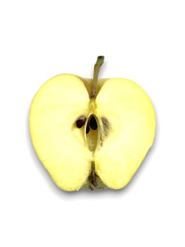 Freshly halved ripe yellow apple displays its core and seeds against white backdrop photo