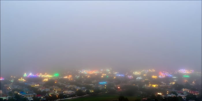 Foggy night view of a town with colorful lights photo