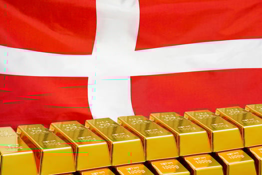Row of gold bars on the Denmark flag background photo