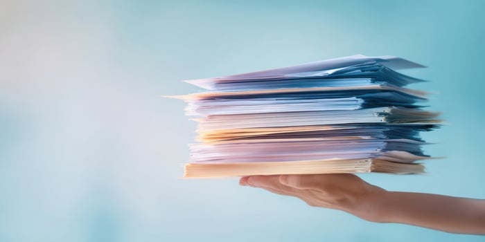The Hand Holding a Stack of Papers in an Organized Business Setting photo