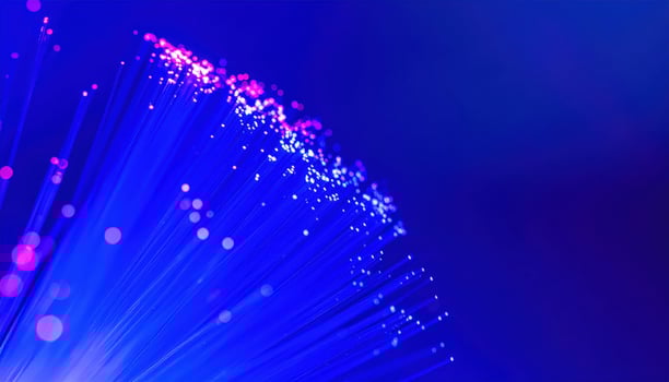 Close up of optical fiber strands glowing with copy space background, ideal for technology themes, digital communication concepts, internet network visuals, data transfer projects, and futuristic photo
