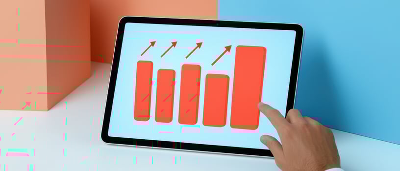 Tablet displaying growth chart with colorful bars and arrows photo