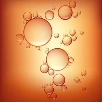3d realistic vector beauty background of oil drops on orange.