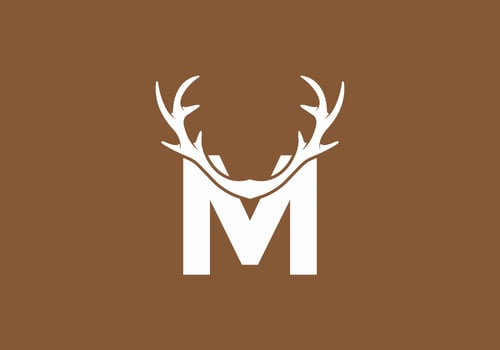 White brown color of M initial letter with deer horn vector