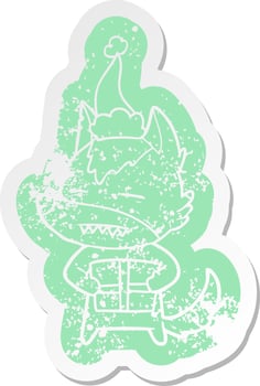 cartoon distressed sticker of a wolf with a gift wearing santa hat vector
