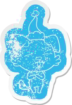 cartoon distressed sticker of a dog sticking out tongue wearing santa hat vector