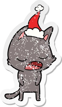 talking cat distressed sticker cartoon of a wearing santa hat vector