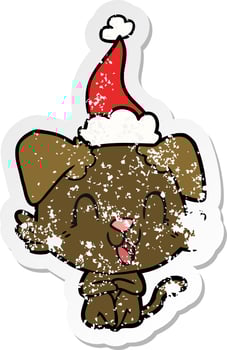 laughing distressed sticker cartoon of a dog wearing santa hat vector