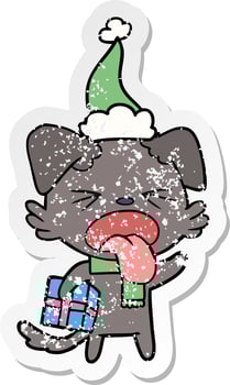 distressed sticker cartoon of a disgusted dog with christmas gift wearing santa hat vector