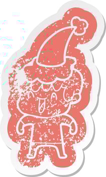 cartoon distressed sticker of a laughing boy wearing santa hat vector