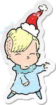 distressed sticker cartoon of a squinting girl wearing santa hat vector