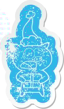cartoon distressed sticker of a pig with christmas present wearing santa hat vector