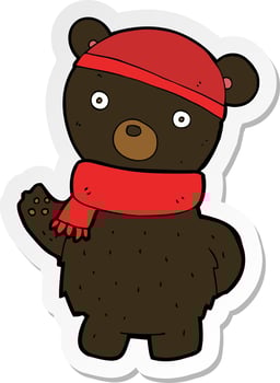 sticker of a cartoon black bear in winter hat and scarf vector