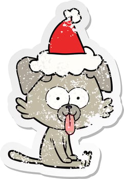 distressed sticker cartoon of a sitting dog with tongue sticking out wearing santa hat vector