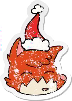 distressed sticker cartoon of a fox face wearing santa hat vector