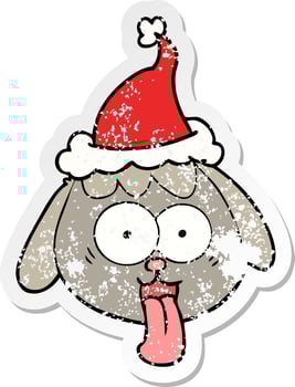 distressed sticker cartoon of a dog face panting wearing santa hat vector