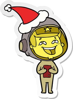 sticker cartoon of a laughing astronaut wearing santa hat vector