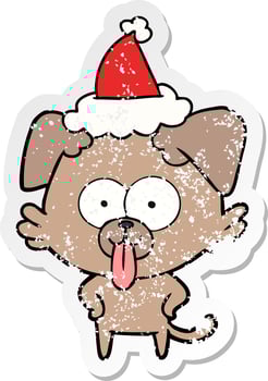 distressed sticker cartoon of a dog with tongue sticking out wearing santa hat vector