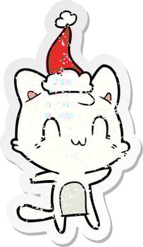 distressed sticker cartoon of a happy cat wearing santa hat vector