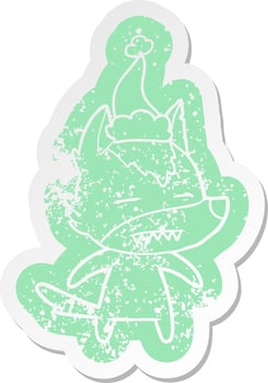 cartoon distressed sticker of a wolf showing teeth wearing santa hat vector
