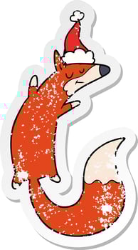 distressed sticker cartoon of a jumping fox wearing santa hat vector