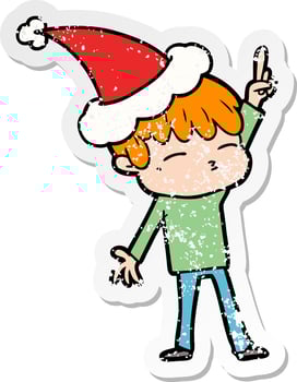 distressed sticker cartoon of a curious boy wearing santa hat vector