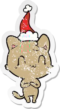 distressed sticker cartoon of a happy cat wearing santa hat vector