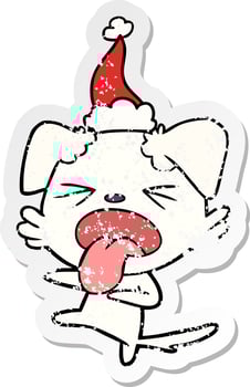 distressed sticker cartoon of a disgusted dog wearing santa hat vector